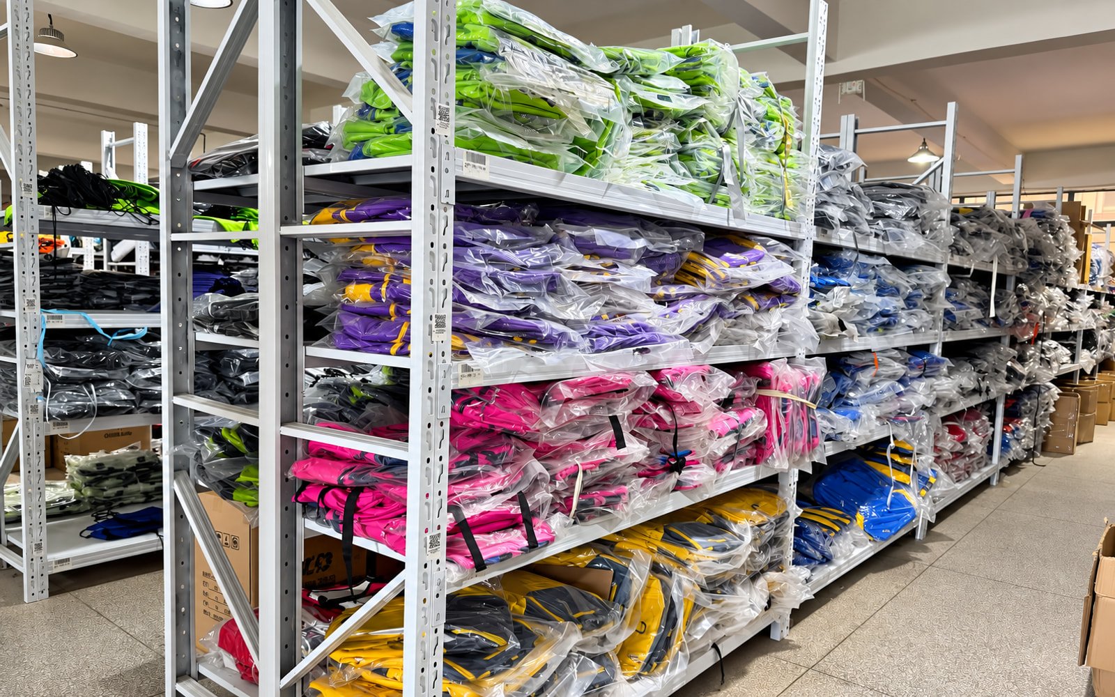Finished custom bags organized by color in factory storage
